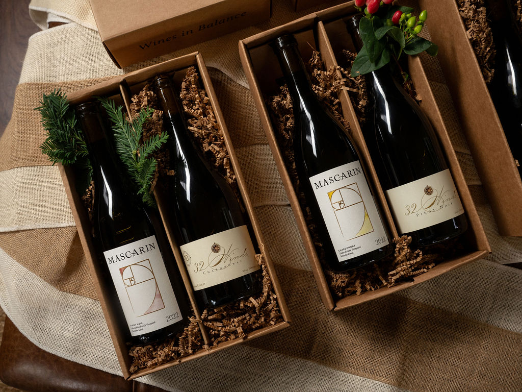 DSC07047 Boxed wine bottles nestled in shredded paper with greenery and flowers.